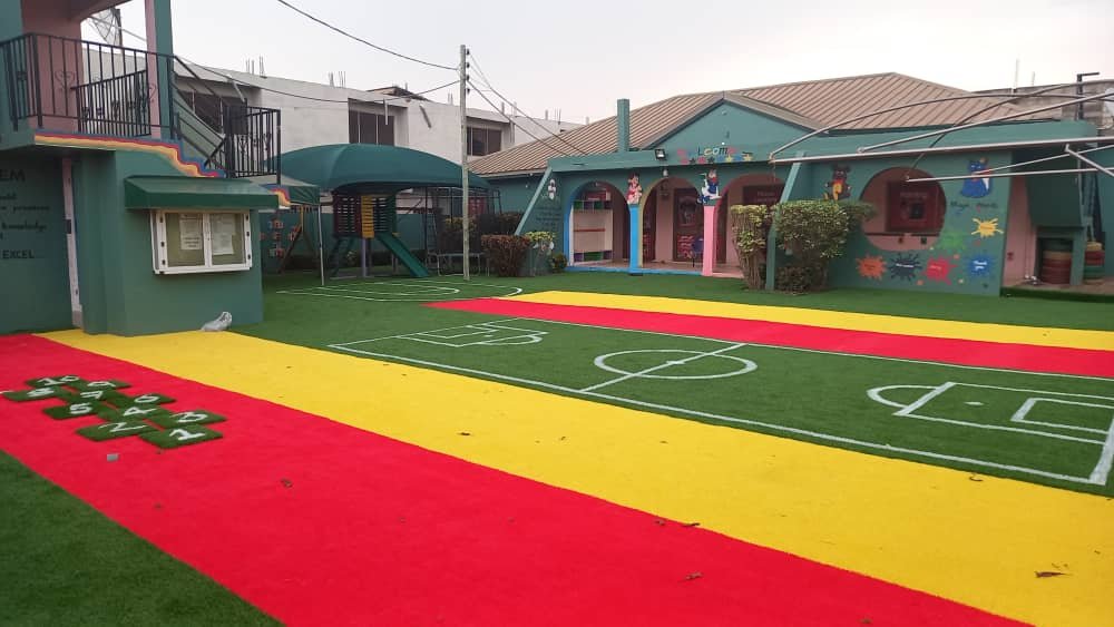 The school playground with a turfed play area and mini football pitch