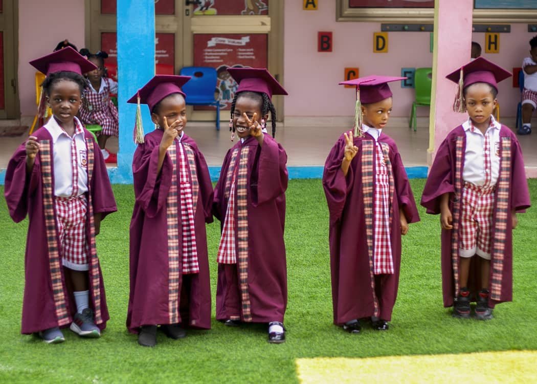 Graduating pupils holding their certificates at the promotion ceremony