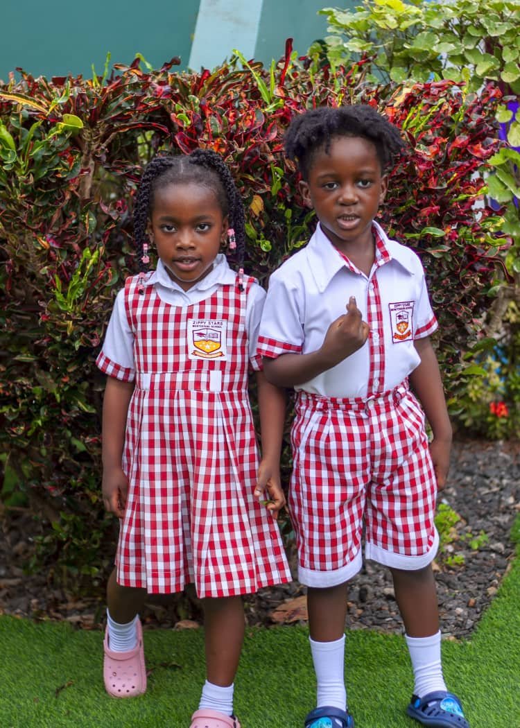Two pupils in Zippy Stars uniform in the school garden