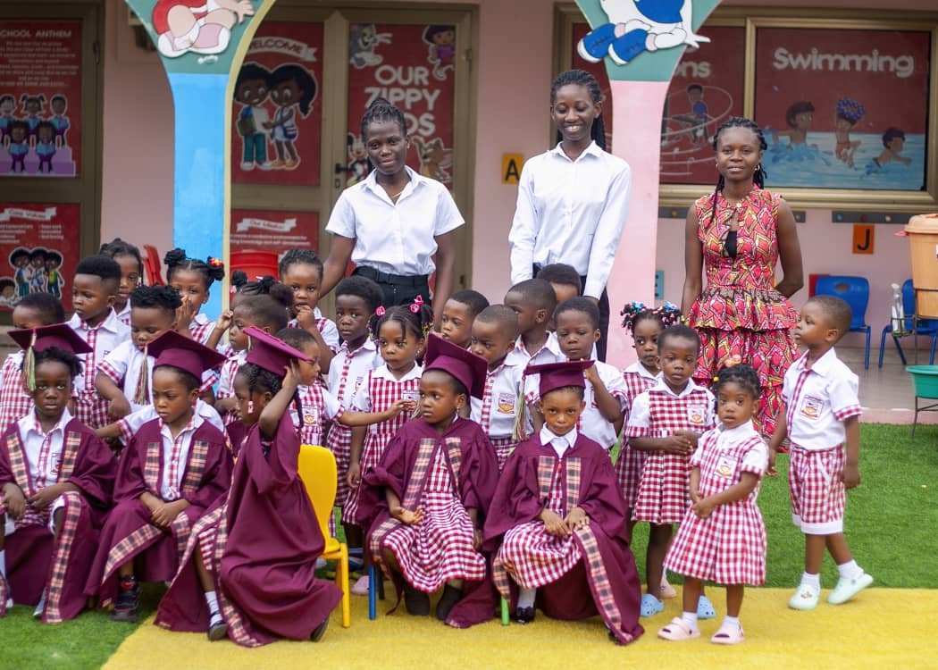 Graduating pupils with their teachers on the school playground