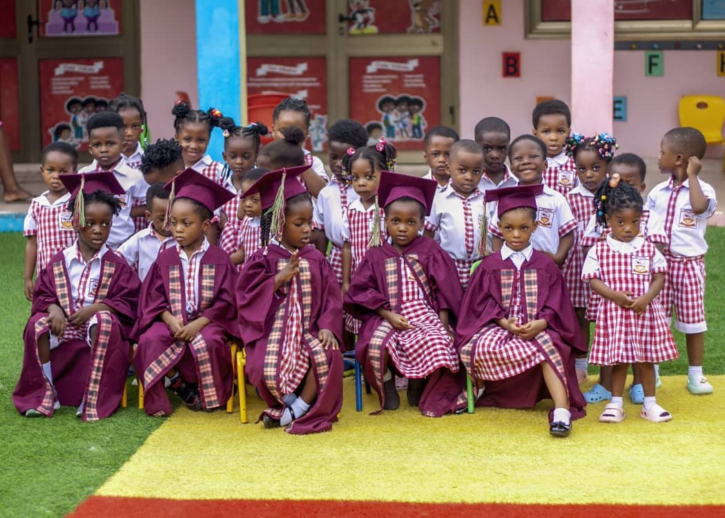 The graduating class posing together in caps and gowns